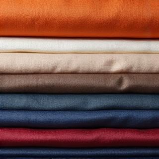 Tumpukan gulungan kain premium dengan berbagai tekstur dan warna.